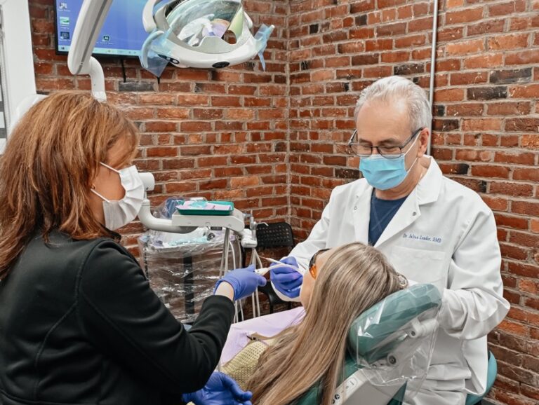 Dentist performing a comprehensive new patient dental exam with a dental assistant at A Plus Dentistry in Brookline, MA.