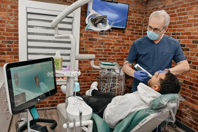 Dentist performing a digital smile scan during a cosmetic smile makeover consultation at A Plus Dentistry.