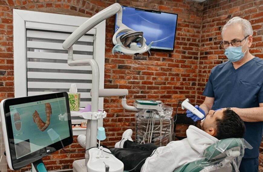 Dentist using a digital scanner to plan Invisalign treatment for a patient at A Plus Dentistry in Brookline, MA.